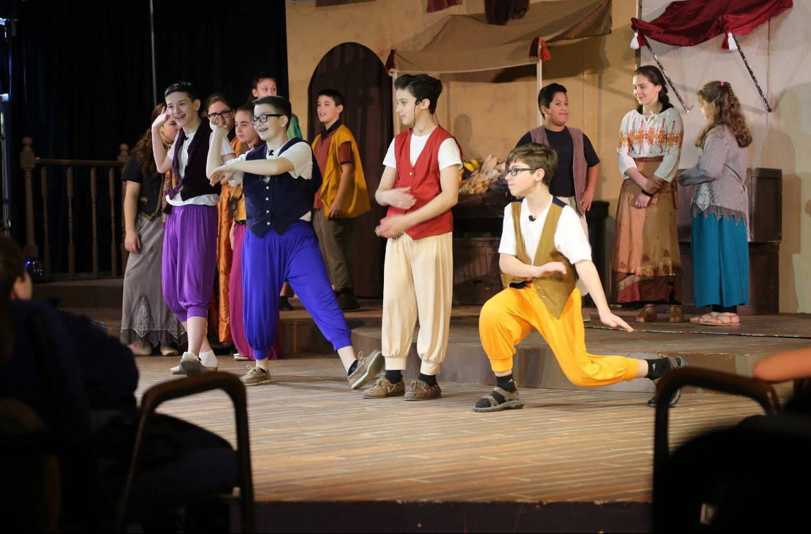 Students performing in a school musical supported by the foundation